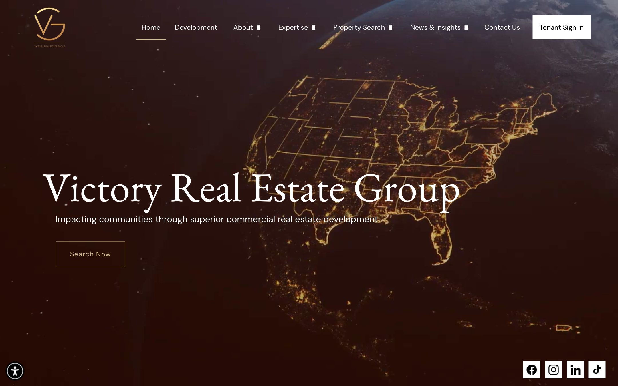 Victory Real Estate Group homepage built by Devdwell — a night satellite map hero behind the company name with a single Search now action